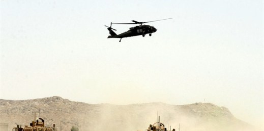A U.S. military helicopter flies over the site of a suicide bombing targeting a NATO convoy in Kandahar, Afghanistan, Aug. 2, 2017 (AP photo).