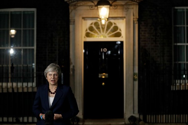 British Prime Minister Theresa May makes a statement on her Cabinet approving a draft Brexit deal, outside 10 Downing Street, London, Nov. 14, 2018 (AP photo by Matt Dunham).