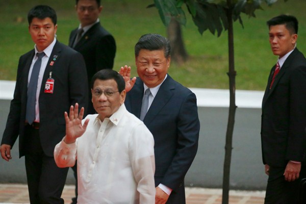 Chinese President Xi Jinping and Philippine President Rodrigo Duterte wave to the media following a welcome ceremony at Malacanang Palace, Manila, Philippines, Nov. 20, 2018 (AP photo by Bullit Marquez).