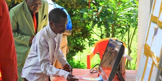 A man demonstrates operating an electronic voting machine that will be used in Congo’s election, Beni, Congo, Oct 16, 2018 (AP photo by Al-hadji Kudra Maliro).