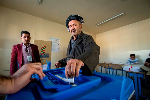 A Kurdish man casts a ballot during parliamentary elections in the autonomous region of Kurdistan, Iraq, Sept. 30, 2018 (DPA photo by Tobias Schreiner via AP Images).