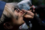 A young man smokes marijuana to celebrate the International Day for Cannabis in Mexico City, April 20, 2018 (AP photo by Eduardo Verdugo).