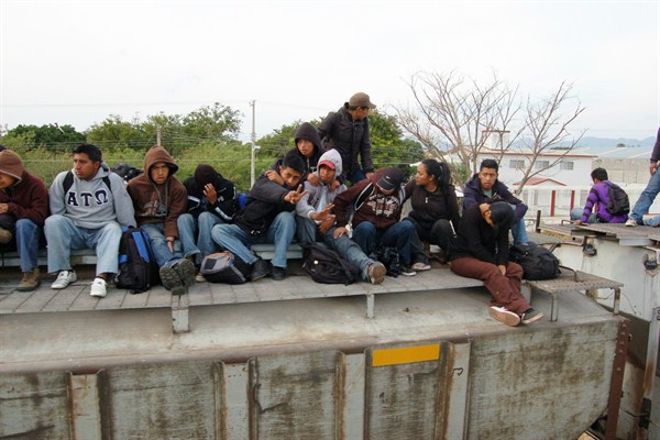 Central Americans riding atop a freight train in Ixtepec, Mexico, in 2012. Since a Mexican government crackdown, scenes like this are rare (Photo by Joseph Sorrentino).
