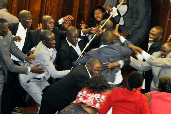 Ugandan opposition MPs scuffle with security trying to eject some of the MPs from Parliament during a debate on the presidential age limit, Kampala, Uganda (AP photo by Ronald Kabuubi).
