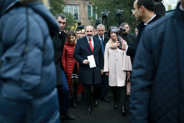 Armenian Prime Minister Nikol Pashinian, center, and his wife, Anna Akobian, leave a polling station during parliamentary elections, Yerevan, Armenia, Dec. 9, 2018 (Photo by Vahan Stepanyan for PAN Photo via AP Images).