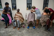 Senegalese migrants who traveled from Cape Verde to Brazil get haircuts before being immunized, Sao Luis, Brazil, May 29, 2018 (Photo by Walker Dawson).