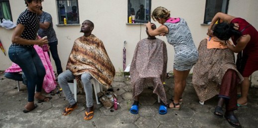 Senegalese migrants who traveled from Cape Verde to Brazil get haircuts before being immunized, Sao Luis, Brazil, May 29, 2018 (Photo by Walker Dawson).