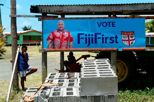 A FijiFirst poster with the image of Fijian Prime Minister Frank Bainimarama is displayed at the entrance to a village in Nausori, Fiji, Nov. 7, 2018 (AP photo).
