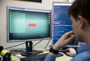 An employee of Global Cyber Security Company Group-IB develops a computer code in an office in Moscow, Russia, Oct. 25, 2017 (AP photo by Pavel Golovkin).