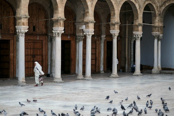 A woman prepares to perform Friday prayers in the courtyard of Zitouna Mosque, the oldest mosque in Tunisia, Tunis, Oct. 23, 2015 (AP photo by Mosa'ab Elshamy).