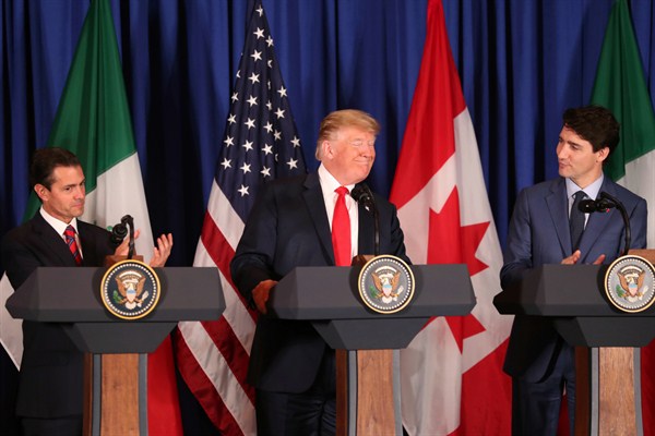 U.S. President Donald Trump, center, Canadian Prime Minister Justin Trudeau, right, and Mexican President Enrique Pena Nieto at a signing ceremony for the new U.S.-Mexico-Canada Trade Agreement, Buenos Aires, Argentina, Nov. 30, 2018 (AP photo).