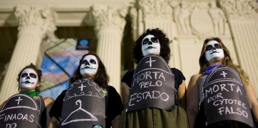 Pro-choice demonstrators wear signs that say “Death by abortion” to show support for the legalization of abortion in Argentina, Rio de Janeiro, Brazil, Aug. 8, 2018 (AP photo by Silvia Izquierdo).