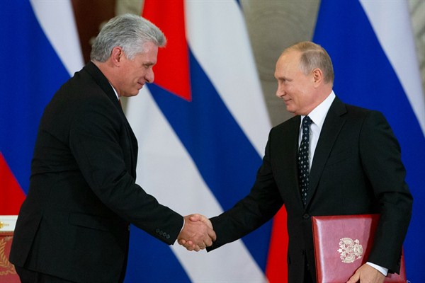 Russian President Vladimir Putin and Cuban President Miguel Diaz-Canel shake hands while exchanging documents after their talks in the Kremlin, Moscow, Russia, Nov. 2, 2018 (AP photo by Alexander Zemlianichenko).