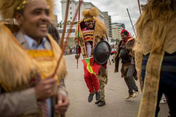 Ethiopians wearing traditional Oromo costumes gather to welcome returning leaders of the once-banned Oromo Liberation Front, Addis Ababa, Ethiopia, Sept. 15, 2018 (AP photo by Mulugeta Ayene).
