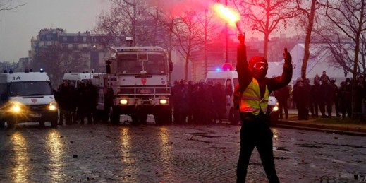 Yellow Vest protesters clash with French riot police near the Hotel des Invalides in Paris, Dec. 1, 2018 (Sipa photo via AP Images). Some see Michel Houellebecq as having foreseen France's Yellow Vest movement.