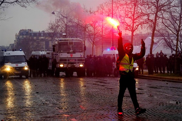 Yellow Vest protesters clash with French riot police near the Hotel des Invalides in Paris, Dec. 1, 2018 (Sipa photo via AP Images). Some see Michel Houellebecq as having foreseen France's Yellow Vest movement.
