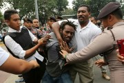 Indonesian police officers arrest a supporter of West Papuan independence during a rally in Jakarta, Indonesia, Aug. 15, 2017 (AP photo by Tatan Syuflana).