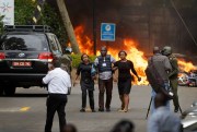 Security forces help civilians flee the scene of the attack at the 14 Riverside hotel-office complex in Nairobi, Kenya, Jan. 15, 2019 (AP photo by Ben Curtis).