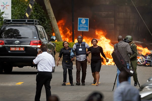 Security forces help civilians flee the scene of the attack at the 14 Riverside hotel-office complex in Nairobi, Kenya, Jan. 15, 2019 (AP photo by Ben Curtis).