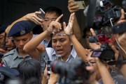 Reuters journalist Kyaw Soe Oo, center, talks to journalists as he leaves the courthouse in Yangon, Myanmar, Sept. 3, 2018 (AP photo by Thein Zaw).