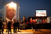 Security agents stand next to a large photograph of Senegalese President Macky Sall at the start of a campaign rally, Dakar, Senegal, March 23, 2012 (AP photo by Rebecca Blackwell).