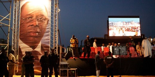 Security agents stand next to a large photograph of Senegalese President Macky Sall at the start of a campaign rally, Dakar, Senegal, March 23, 2012 (AP photo by Rebecca Blackwell).
