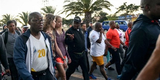 South African President Cyril Ramaphosa, center with black cap, goes for a walk with members of the public, Cape Town, South Africa, Feb. 20, 2018 (AP photo).