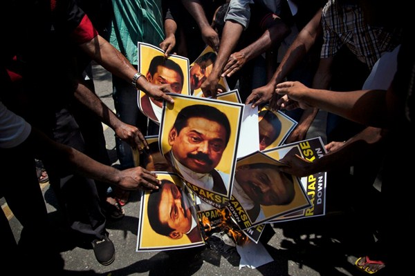 Supporters of Marumalarchi Dravida Munnetra Kazhagam, an Indian political party, burn portraits of  Sri Lankan President Mahinda Rajapaksa during a protest, New Delhi, India,  May 26, 2014 (AP photo by Tsering Topgyal).