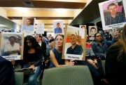 Attendees at a hearing of the Inter-American Commission on Human Rights display photos of people who went missing while trying to cross the border from Mexico into the United States, Boulder, Colorado, Oct. 5, 2018 (AP photo by David Zalubowski).