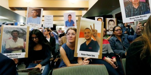 Attendees at a hearing of the Inter-American Commission on Human Rights display photos of people who went missing while trying to cross the border from Mexico into the United States, Boulder, Colorado, Oct. 5, 2018 (AP photo by David Zalubowski).