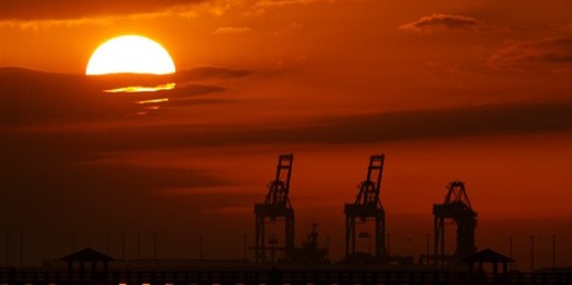 Cranes at the Port of Gulfport are silhouetted by the setting sun in Gulfport, Mississippi, Dec. 2, 2018 (AP photo by Charlie Riedel).