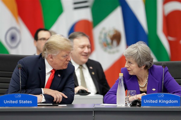 British Prime Minister Theresa May listens to U.S. President Donald Trump during the G-20 summit in Buenos Aires, Argentina, Nov. 30, 2018 (AP photo by Natacha Pisarenko).
