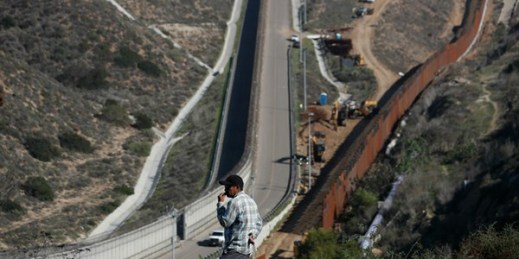 A man looks out at the U.S. border where workers are replacing parts of the U.S. border wall for a higher one, Tijuana, Mexico, Dec. 19, 2018 (AP photo by Moises Castillo).