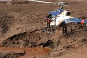 A helicopter flies over the mud in search of bodies, days after a mining company’s dam collapsed in Brumadinho, Brazil, Jan. 30, 2019 (AP photo by Andre Penner).