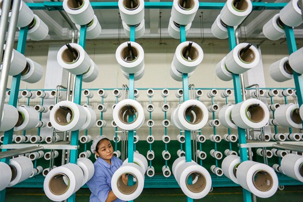 A woman works in a weaving factory in Jinjiang, in southeast China’s Fujian province, Nov. 22, 2018 (Chinatopix photo via AP Images).