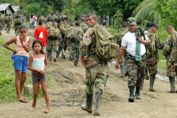 Paramilitary fighters from the “Banana Bloc” arrive at a rural area outside the northwestern Colombian town of Turbo to turn in their arms, Nov. 21, 2004 (Photo by Julio Cesar Herrerea for El Tiempo via AP Images).