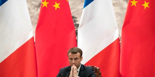 French President Emmanuel Macron watches a signing ceremony between French and Chinese firms at the Great Hall of the People in Beijing, Jan. 9, 2018 (AP photo by Mark Schiefelbein).