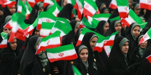 Iranians wave national flags during a ceremony celebrating the 40th anniversary of the Islamic Revolution, at the Azadi, in Tehran, Iran, Feb. 11, 2019 (AP photo by Vahid Salemi).