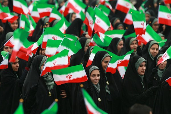 Iranians wave national flags during a ceremony celebrating the 40th anniversary of the Islamic Revolution, at the Azadi, in Tehran, Iran, Feb. 11, 2019 (AP photo by Vahid Salemi).