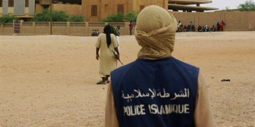 An Islamic Police officer walks through the square where members of the group Ansar Dine were preparing to publicly lash a person found guilty of adultery, Timbuktu, Mali, Aug. 31, 2012 (AP photo).