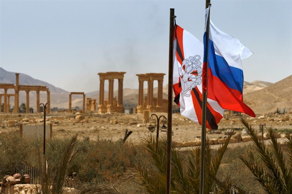 Russian flags in front of the ancient ruins of Palmyra, Syria, April 8, 2016 (Russian Defense Ministry Press Service photo via AP).