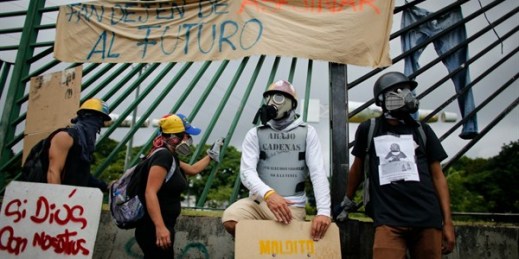 Venezuelan protesters wearing helmets and gas masks near La Carlota air base, Caracas, June 24, 2017 (AP photo by Ariana Cubillos).