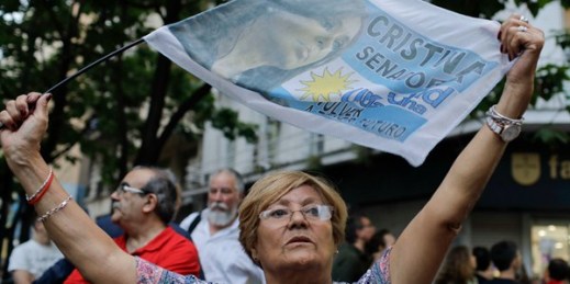 A woman holds a flag decorated with a picture of Argentina’s former president, Cristina Fernandez, during a rally to show support for her, Buenos Aires, Argentina, Dec. 7, 2017 (AP photo by Natacha Pisarenko).