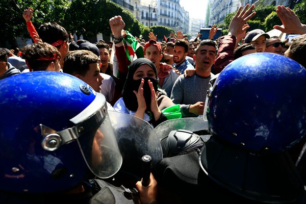 High school students face riot police officers as they protest in Algiers, Algeria, March 12, 2019 (AP photo by Toufik Doudou).
