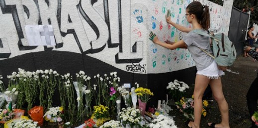 A student places her handprints on a wall at the Raul Brasil State School one day after a mass shooting, Suzano, Brazil, March 14, 2019 (AP photo by Andre Penner).