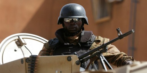 A soldier stands guard outside a hotel after an attack in Ouagadougou, Burkina Faso, Jan. 18, 2016 (AP photo by Sunday Alamba).