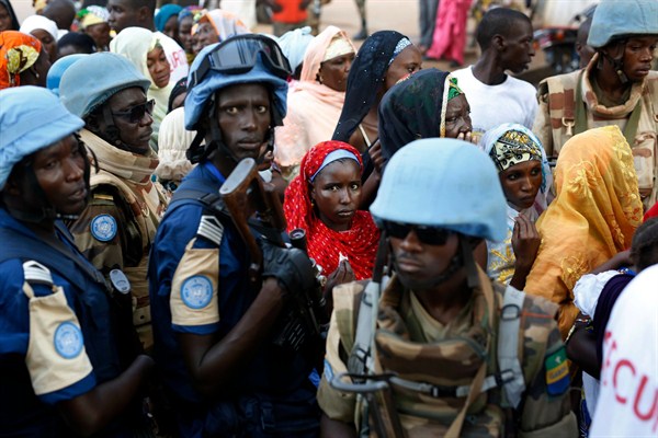 U.N. peacekeepers stand near people queuing to enter a mosque during the visit of Pope Francis, Bangui, Central African Republic, Nov. 30, 2015 (AP photo by Jerome Delay).