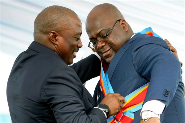 Congolese President Felix Tshisekedi receives the presidential sash from outgoing President Joseph Kabila after being sworn in, Kinshasa, Democratic Republic of Congo, Jan. 24, 2019 (AP photo by 	Jerome Delay).