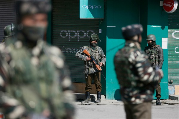 Indian paramilitary soldiers stand guard outside a closed market, Srinagar, India, March 5, 2019 (AP photo by Mukhtar Khan).