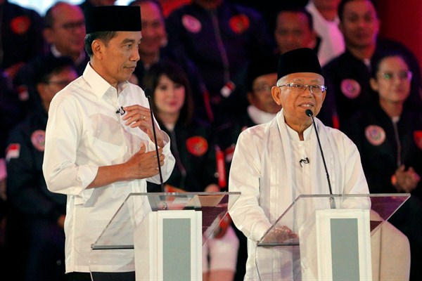 Indonesian President Joko Widodo listens as his running mate, Ma'ruf Amin, delivers a speech during a televised debate in Jakarta, Indonesia, Jan. 17, 2019 (AP photo by Tatan Syuflana).